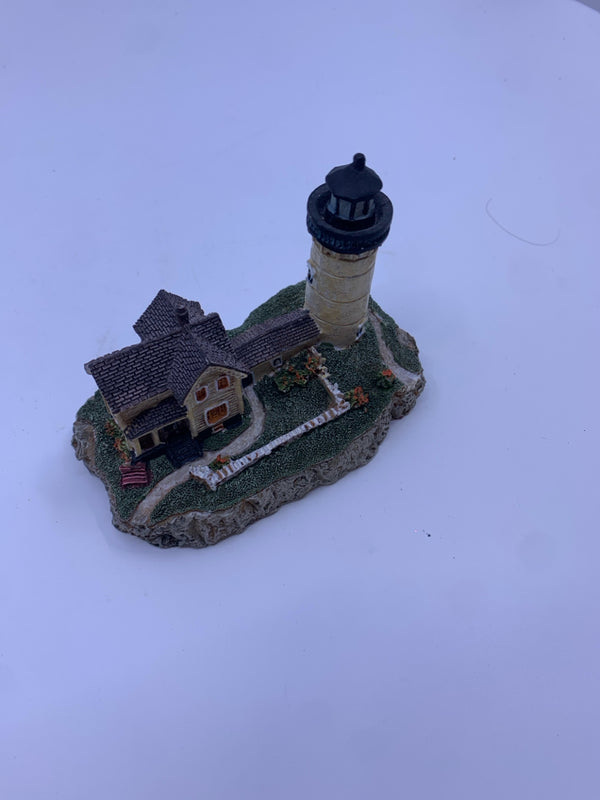 TAN HOUSE AND LIGHTHOUSE W/ BROWN ROOF.