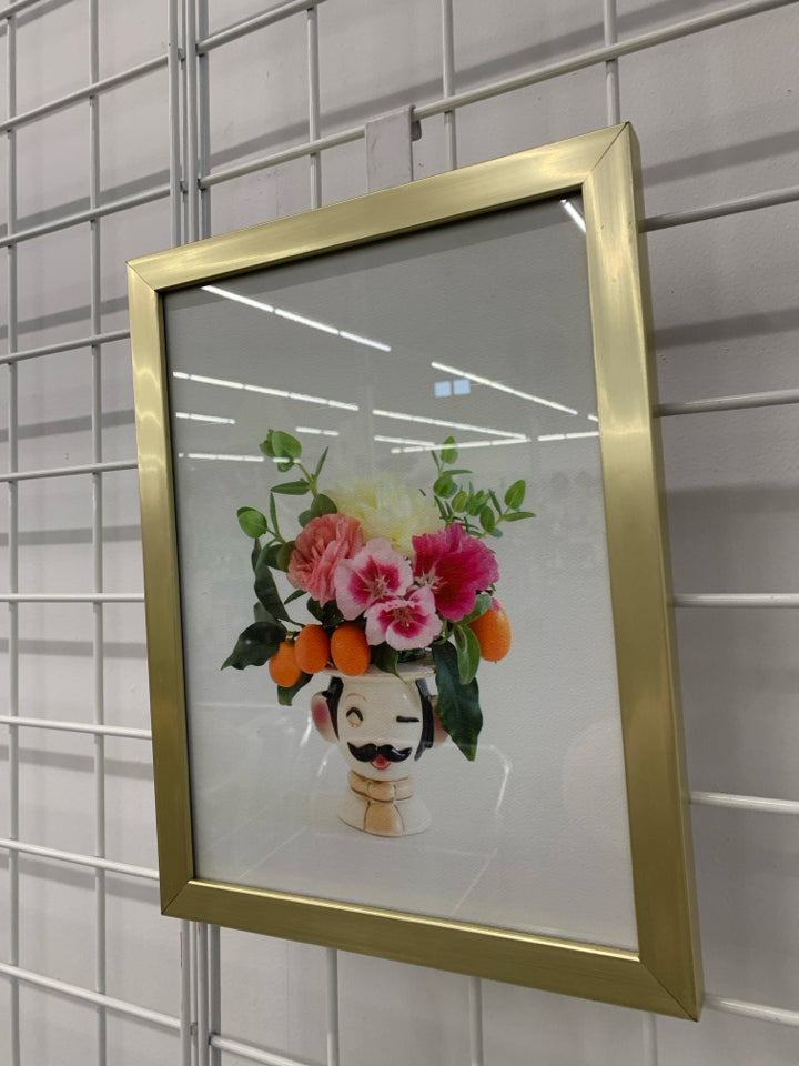 PINK FLOWERS IN FACE PLANTER IN GOLD FRAME WALL HANGING.