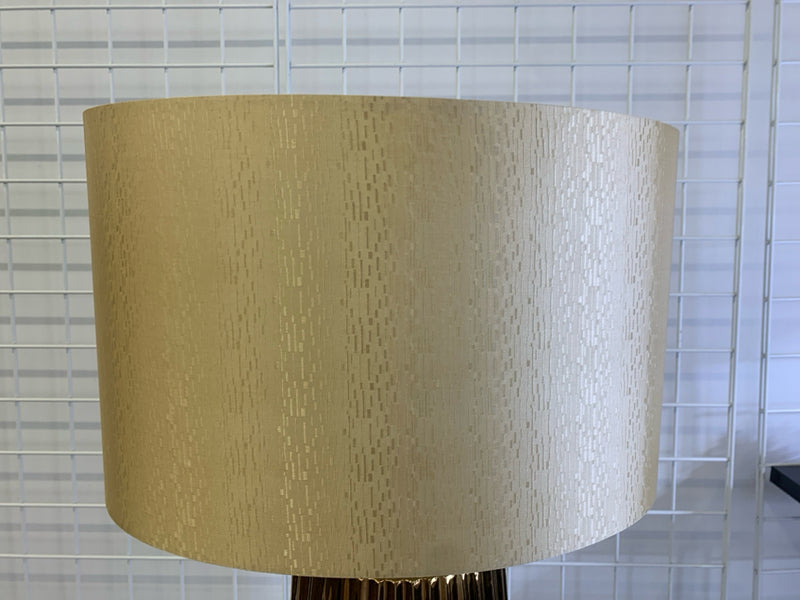 TALL CERAMIC RIBBED GOLDEN LAMP W/ GOLDEN TEXTURED SHADE.