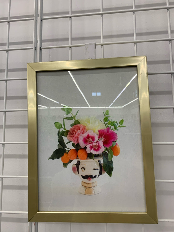 PINK FLOWERS IN FACE PLANTER IN GOLD FRAME WALL HANGING.