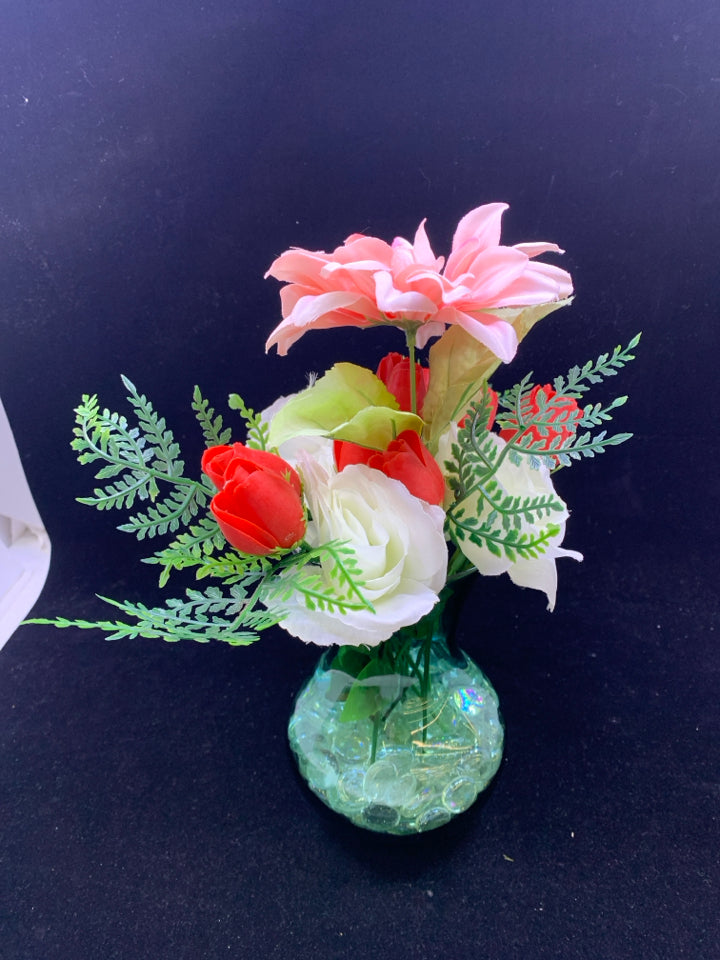 GREEN GLASS VASE WITH PINK WHITE AND RED FLOWERS.