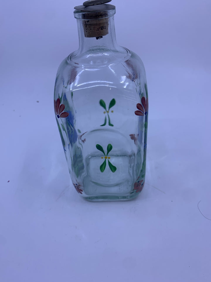 GLASS JAR WITH FLOWERS AND CORK STOPPER.